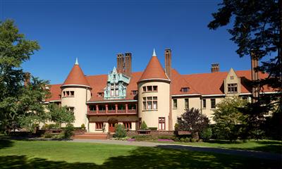 View Photo #1 - View of front lawn surrounded by lush gardens