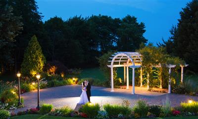 View Photo #19 - Bride and groom kissing by garden