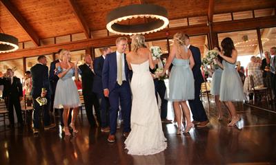 View Photo #5 - Bride and groom with guests inside reception room