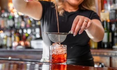 View Photo #8 - Drink being strained into a glass