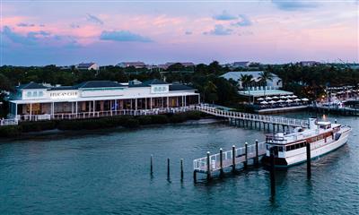 View Photo #1 - Aerial photo at sunset of Pelican Club with Honey Fitz docked